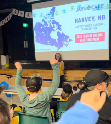 A student celebrates the announcement of the Harvey Minor Baseball Association receiving a $92,050 grant from the Toronto Blue Jays’ Jays Care Field of Dreams program to upgrade the sports field at Harvey High School.