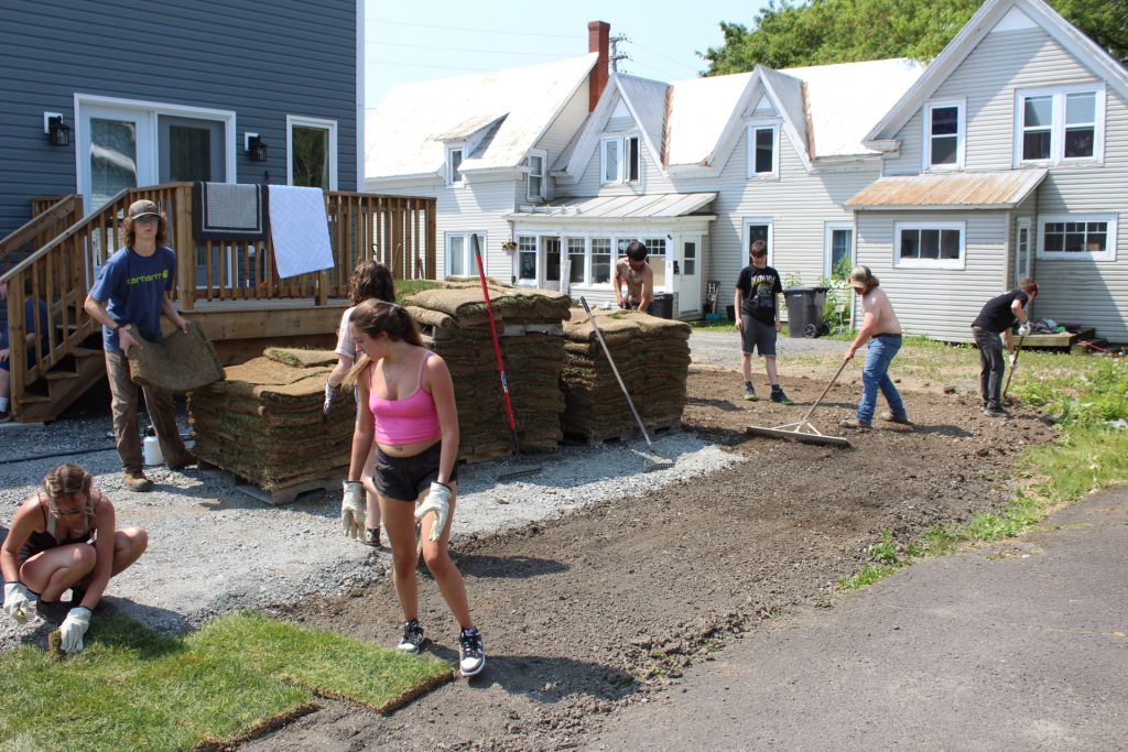 Students from Stanley Consolidated School work on landscaping at a Habitat for Humanity property in Fredericton.