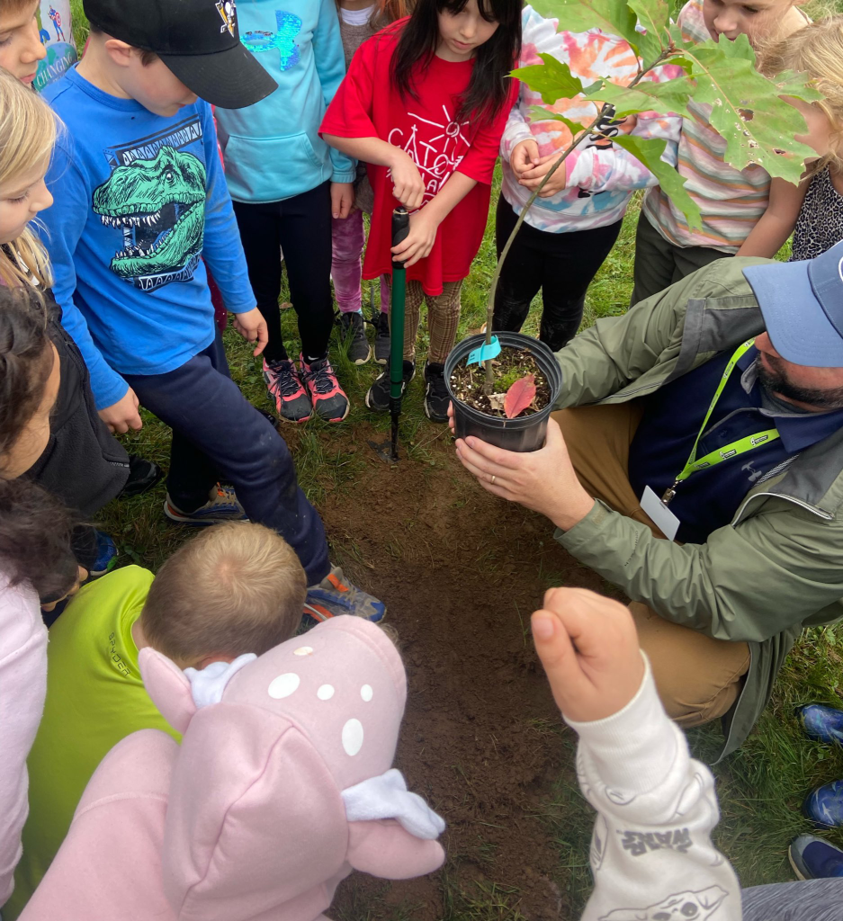 A teacher and students plant a tree at Barkers Point School for Take Me Outside Day. Barkers Point chose to honour the day on Oct. 16, 2023.
