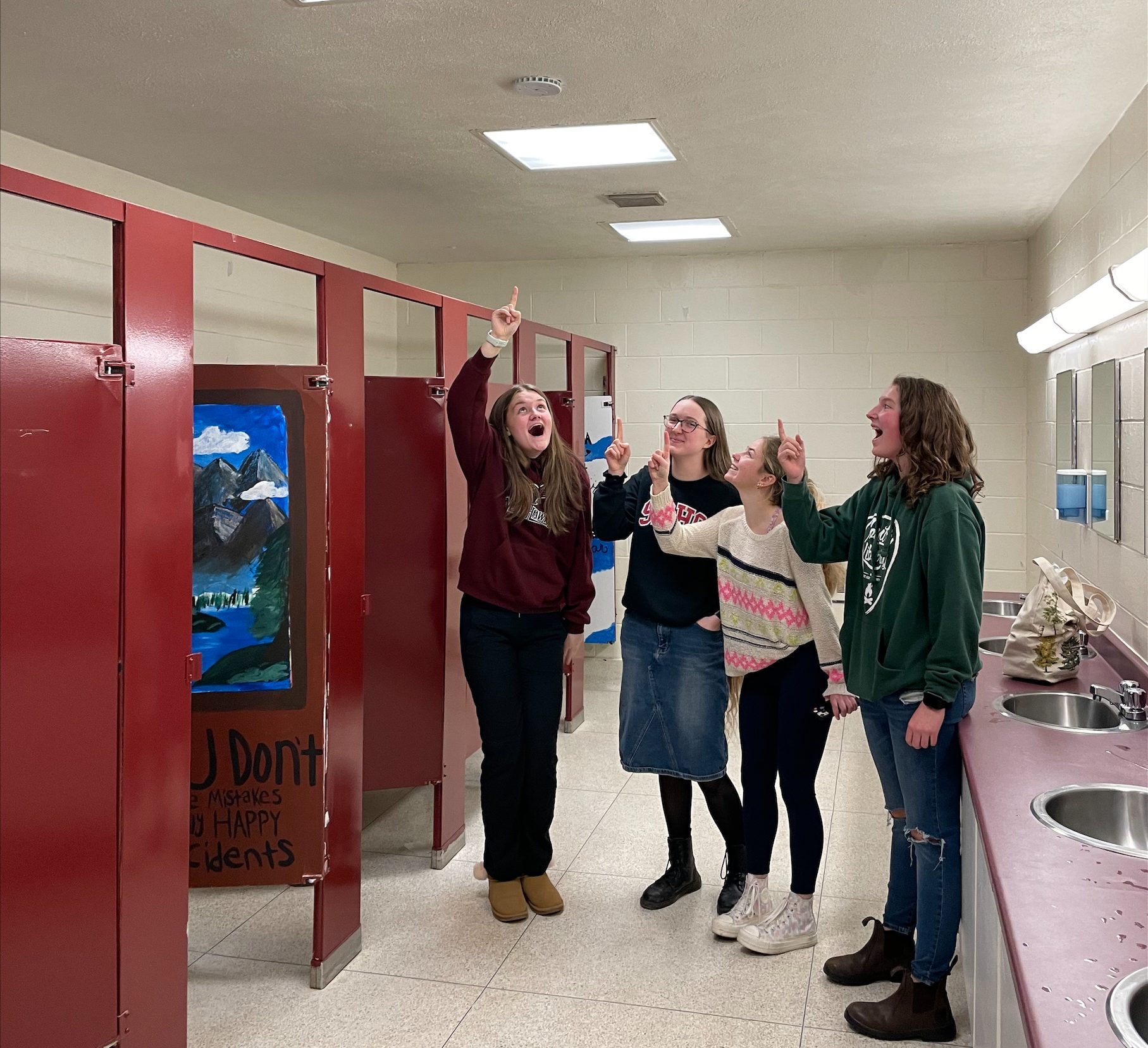 (l-r) Members of Nackawic Senior High School's STOMP Student Council Georgia Eastwood, Grade 10, and Grade 12 students Emma Hovey, Aselin Calder, and Hailey Nason, showing one of the HALO-brand vape detectors in a school bathroom.