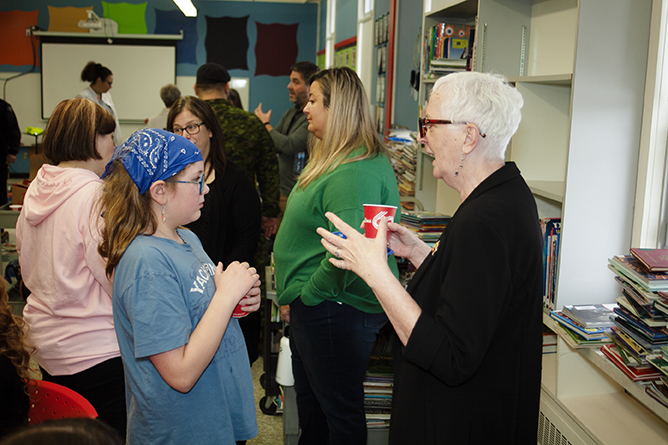 Hubbard Elementary School Grade 4 student Adeline Hogeveen (L) speaks with New Brunswick Lt.-Gov. Brenda Murphy (R) during the school's annual Read-In on Jan. 26, 2024.