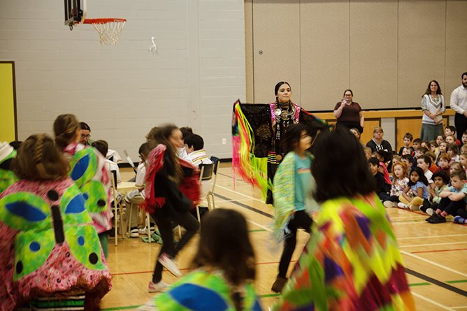 Abby Brooks, a teacher and fancy shawl dancer from Sitansisk/St. Mary’s First Nation, leads students in an Indigenous dance at Gibson-Neill Memorial Elementary School on Friday, Feb. 2, 2024.