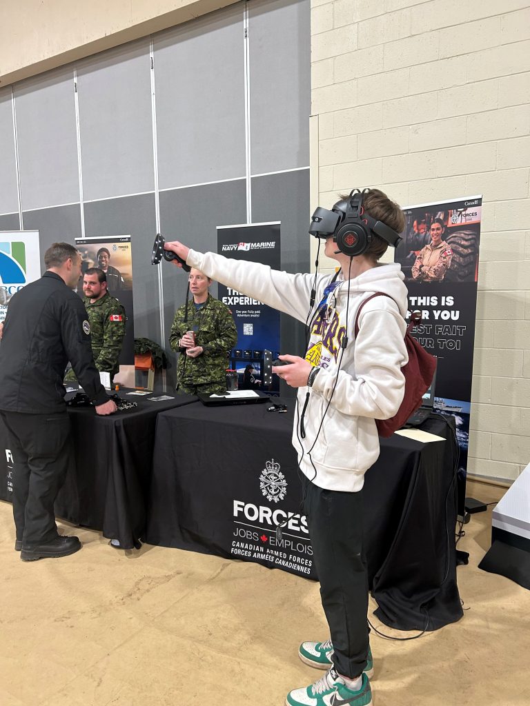 A Cambridge-Narrows Community School student uses virtual reality goggles during the Interactive Skilled Trades and Manufacturing Expo at the school on March 14.