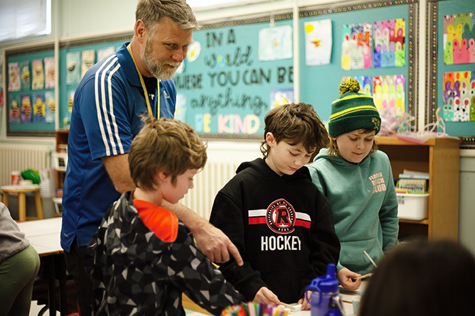 Keswick Ridge School Principal Jeff Taylor helps students during the Centre of Excellence’s Skilled Trades and Manufacturing online “Sugar Shack: A LIVE Masonry Event” at the school on March 28.