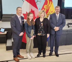 President of the New Brunswick Teachers’ Association Peter Legacy, Grade 5 student Maggie Charters, Harvey Elementary School Principal Julie Holt, and Education and Early Childhood Development Minister Bill Hogan.