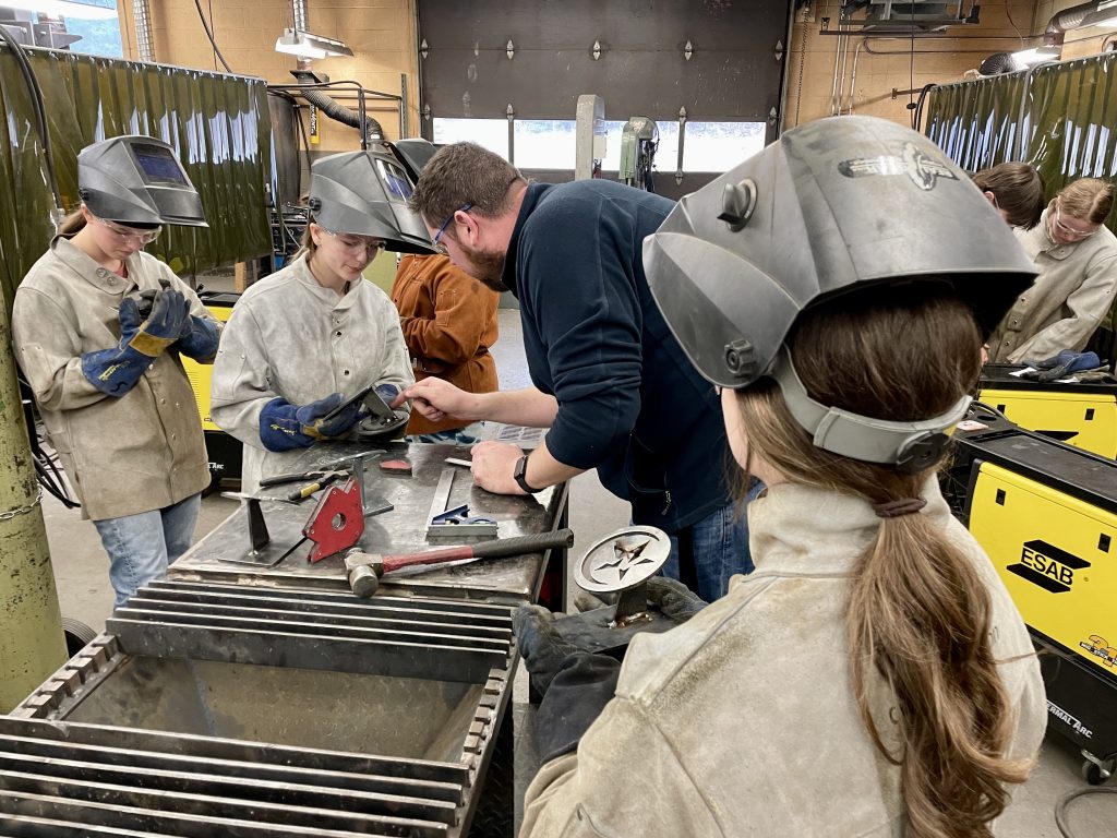 Shop shop teacher Ken Robins works with Grade 11 students Ivy MacDonald (left) and Holly Moores (centre) during a Women-in-Trades event at Carleton North High School on April 12.