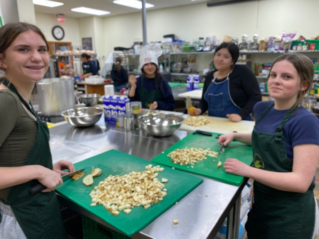 Devon Middle School students spent several hours in the kitchen at Fredericton's Greener Village community kitchen on April 17, 2024. Students worked with chef Yves Dechaine to prepare meals to feed Greener Village clients, as part of a lesson on food insecurity.