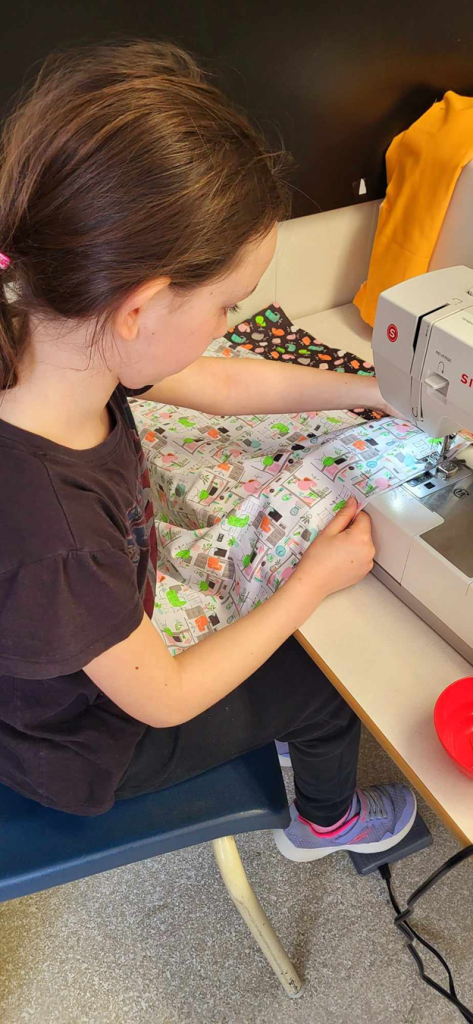 A Keswick Ridge School student sews a "hot dog" pillowcase during the school's three-week-long Enrichment Wednesday Afternoons in March and April.