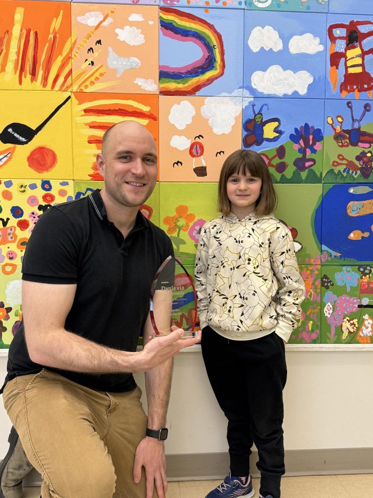 Charles MacTavish, an academic support teacher for reading and numeracy at Geary Elementary Community School, with student Raelyn Burke. Burke's mother nominated MacTavish for the Dyslexia Canada Educator of Excellence Award.