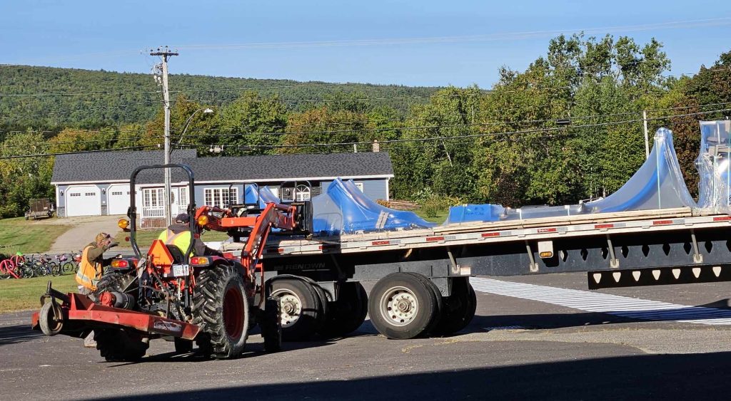 Workers bring in new playground equipment for the McAdam Elementary School playground.