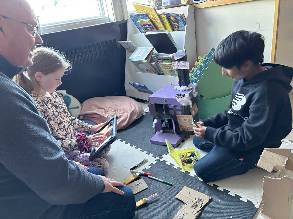 ASD-W Digital Learning Lead Jeff Whipple works with students at Park Street Elementary School on their micro:bit-enhanced Halloween dioramas.