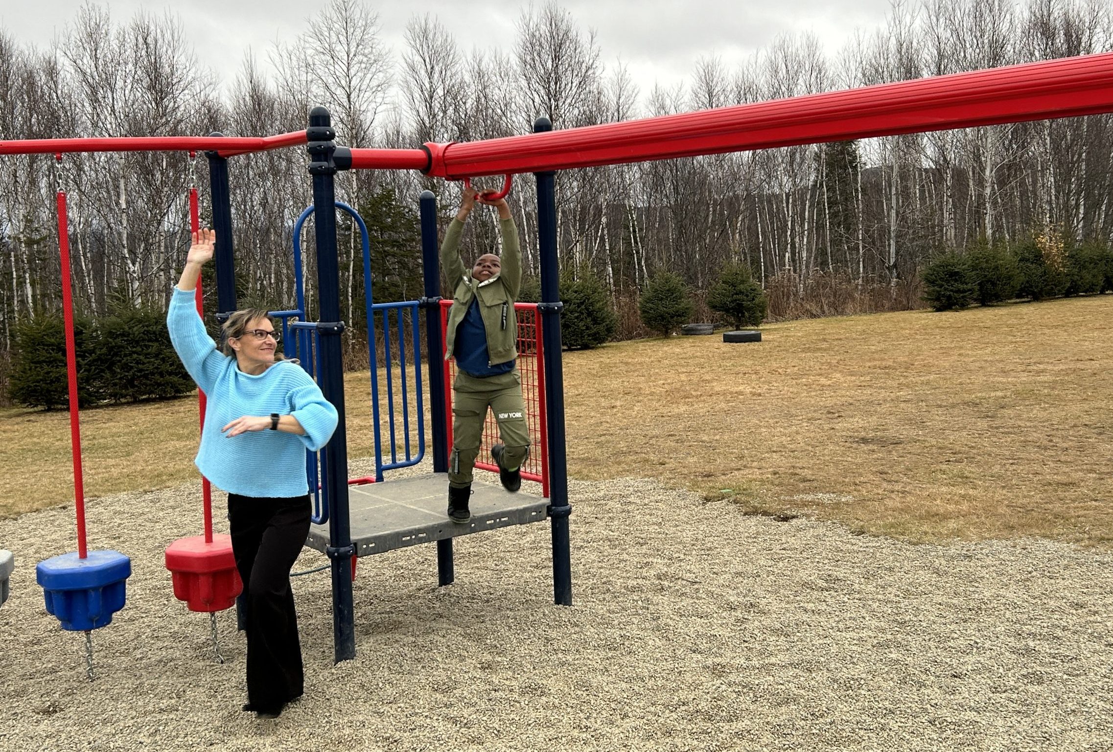 Saint Mary's Academy Principal Julie Michaud with Grade 4 student Cyruss Ahountsa Namekong on the new zipline feature, at the unveiling of the school's refurbished playground, on Friday, Nov. 22, 2024.