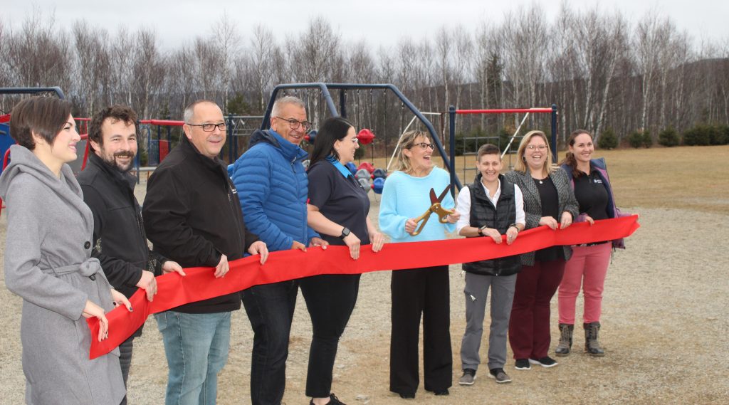 L-R Rosie and Alex Bernard of the Edmundston Fish Market, Edmundston Mayor Eric Marquis, Marc Ouellette of ELAN Jeunesse, PSSC Chairwoman Shirley Pelletier, SMA Principal Julie Michaud, SMA Vice-Principal Heather Dexter, educational assistant Melanie Dube-Steeves, and Parents Volunteer Committee member Marie-Helene Landry cut the ribbon unveiling the refurbished Saint Mary's Academy playground on Friday, Nov. 22, 2024. Photo Credit: David Blanchfield