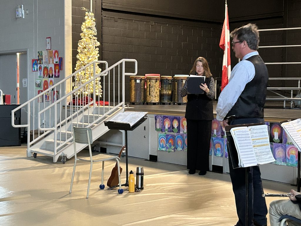 Fredericton Mayor Kate Rogers reads the proclamation for the King Charles III Coronation Medal before presenting it to her brother, teacher Andrew Rogers, at Connaught Street School, on Wednesday, Dec 11, 2024. 