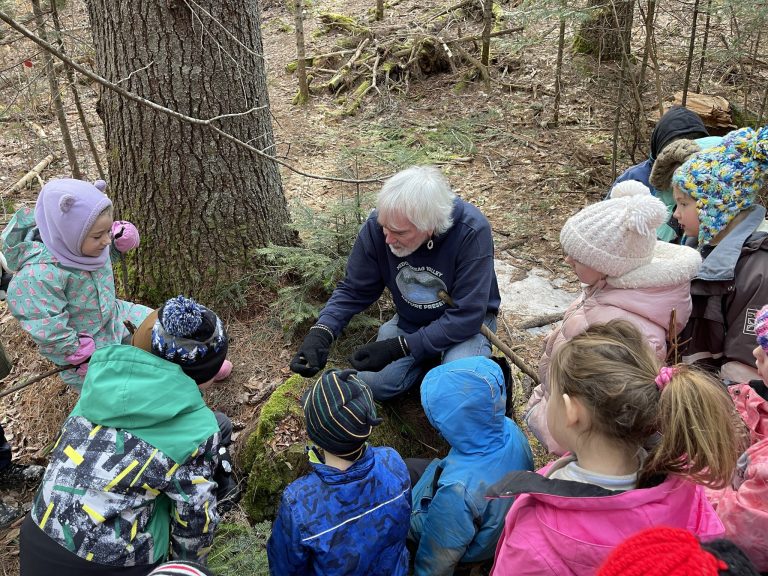 MRA Administrator George Peabody teaches Meduxnekeag Consolidated School Grade 2 students about soil and plants on an outing at the Meduxnekeag Valley Nature Preserve in March. Photo Credit: MRA