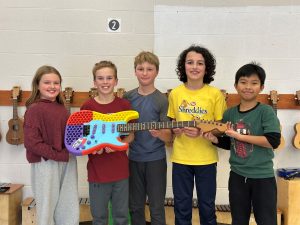 (L-R) Garden Creek School Grade 5 students Violet O’Connor, Will Thompson, Liam Geburt, Miles Rajput, and Peter Estrella used Computer-aided Design (CAD) and 3D printing to design and build a working electric guitar. The project helped reinforce students' music, math, and science skills.