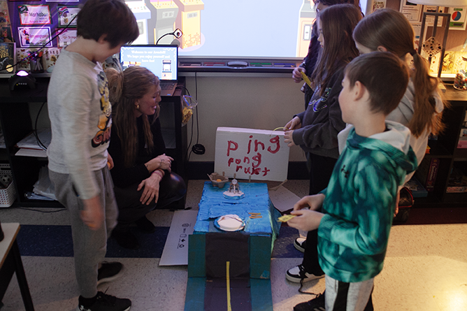 Teacher Kristen Nixon works with students at the games arcade her class created at Connaught Street School.