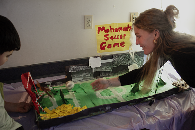 Teacher Kristen Nixon works with a student at the games arcade her class created at Connaught Street School.