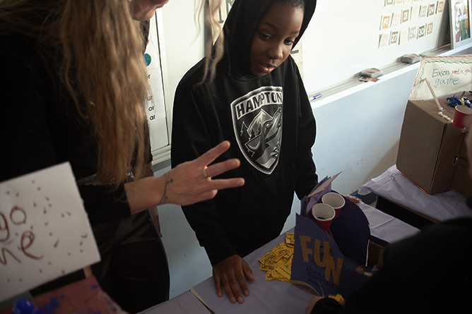 Teacher Kristen Nixon works with a student at the games arcade her class created at Connaught Street School.