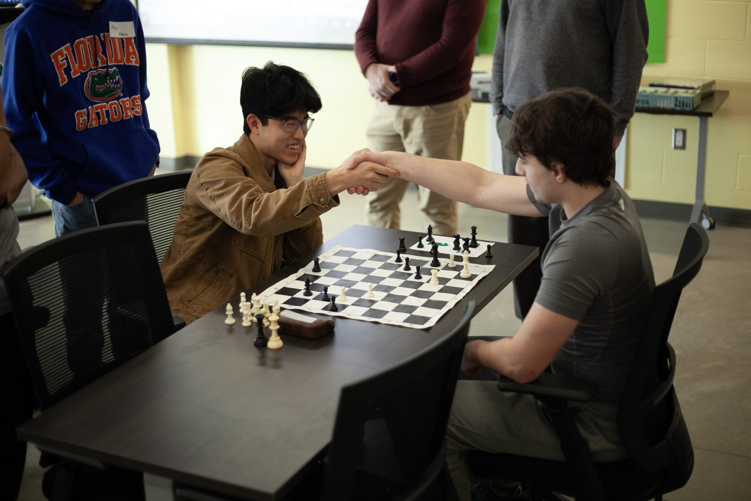 Students congratulate each other on a well-played game at the annual FEC/OEC high school chess tournament at Hanwell Park Academy, on Feb. 20.