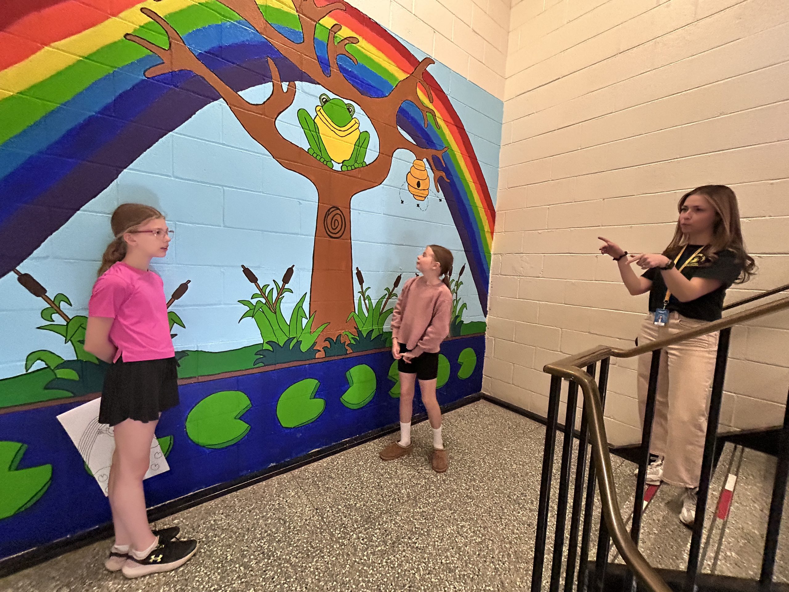 (L-R) Garden Creek School Grade 5 students Sydney Pearce, Lucy Spink, and their teacher Jacqueline Saunders in front of the mural they helped paint at the school.