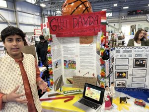 Grade 9 FHS student Pranav Shukla explains his project on gilli danda, the traditional Indian game that forms the basis of both cricket and baseball, at the 2025 Regional Heritage Fair at Fredericton's Grant Harvey Centre, on Wednesday, May 7.