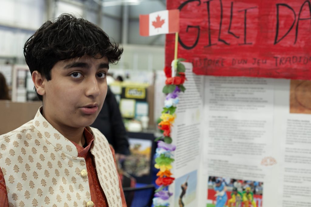 Grade 9 FHS student Pranav Shukla explains his project on gilli danda, the traditional Indian game that forms the basis of both cricket and baseball, at the 2025 Regional Heritage Fair at Fredericton's Grant Harvey Centre, on Wednesday, May 7.